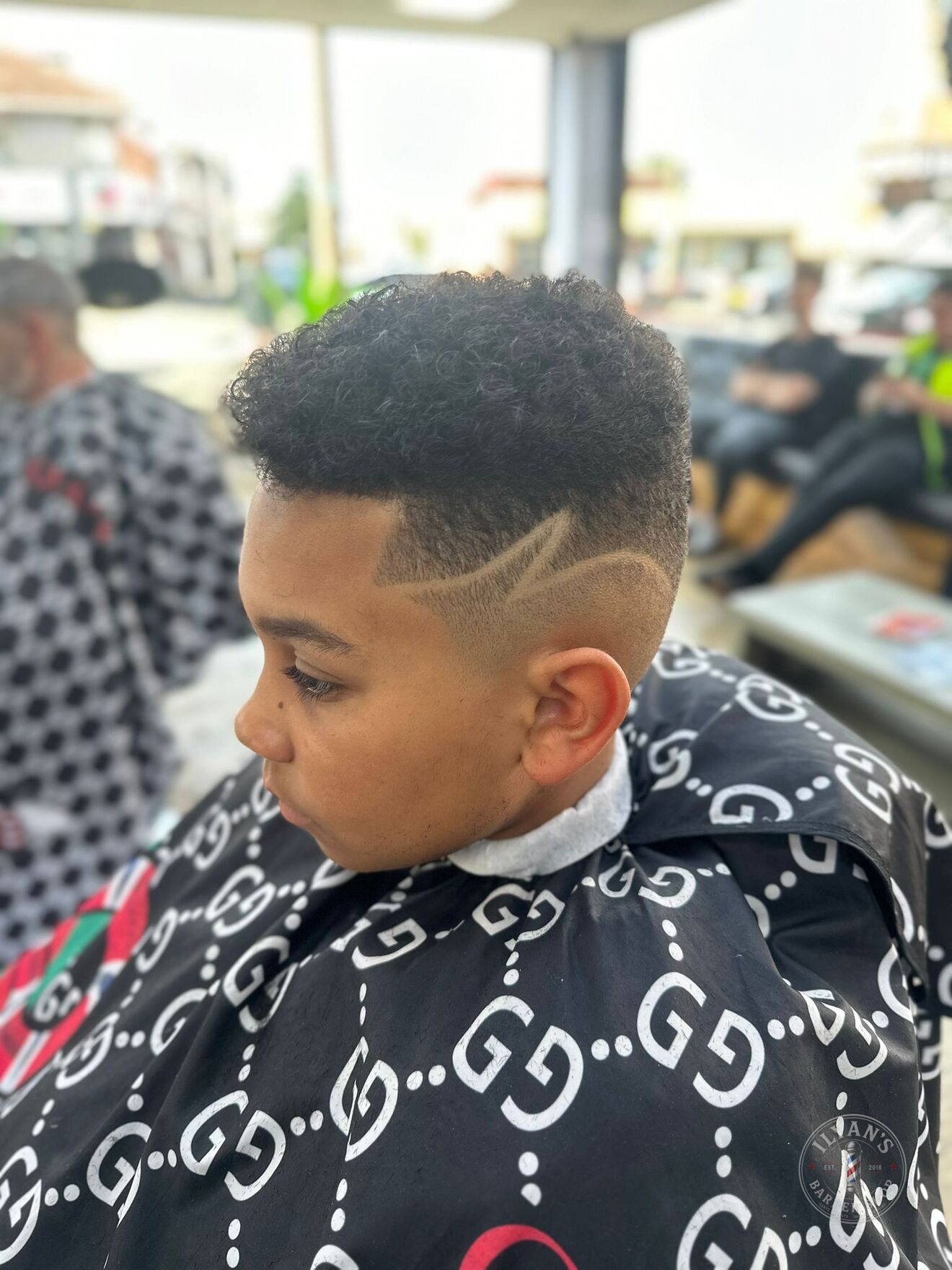 Curly High Top Fade with Design at Ilyan's Barber Shop